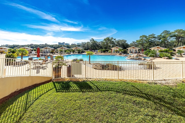 view of swimming pool featuring a lawn and a patio