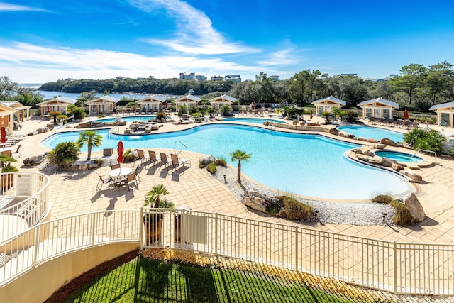 view of pool with a patio and a hot tub