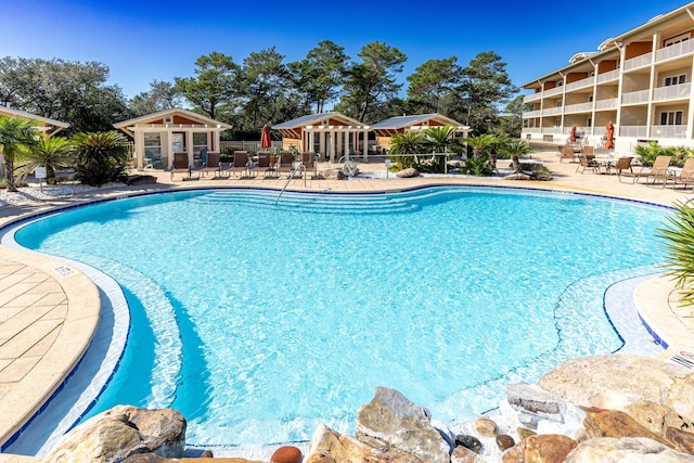 view of swimming pool with a patio and an outdoor structure