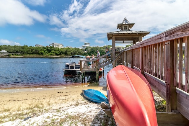 dock area with a water view and a view of the beach