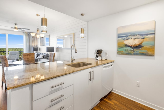 kitchen with sink, decorative light fixtures, dishwasher, dark hardwood / wood-style floors, and white cabinetry