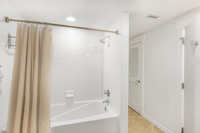 bathroom featuring tile patterned flooring and shower / bath combo