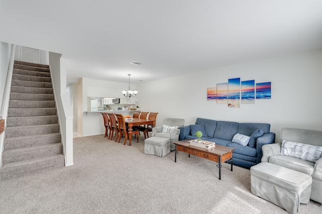 living room with carpet flooring and a chandelier