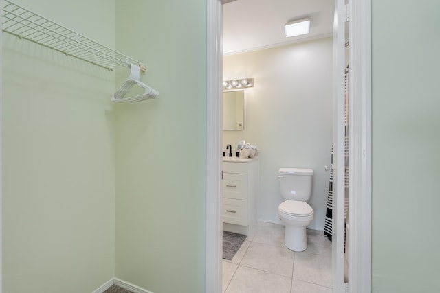 bathroom featuring tile patterned flooring, vanity, and toilet