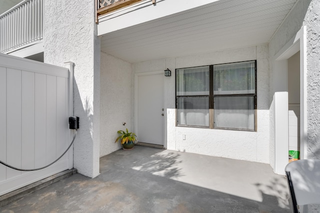 view of exterior entry with a patio area