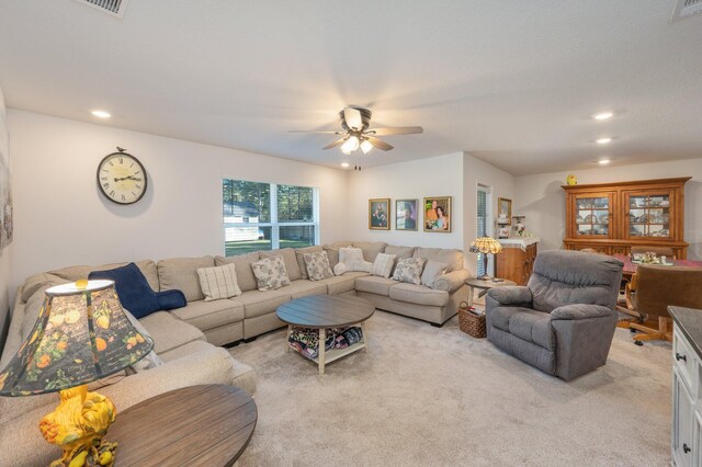 carpeted living room with ceiling fan