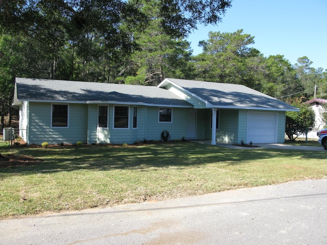 ranch-style home with a garage and a front lawn