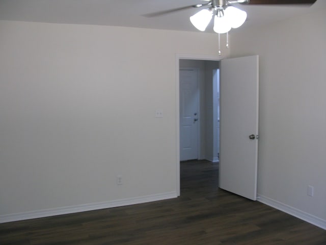 spare room with dark hardwood / wood-style floors and ceiling fan