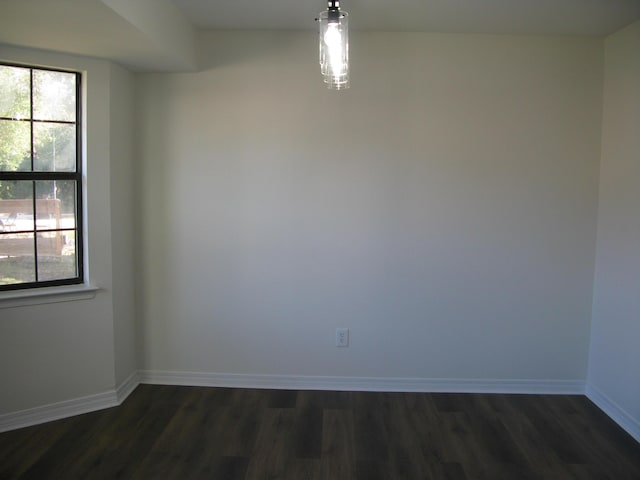 empty room with dark hardwood / wood-style floors