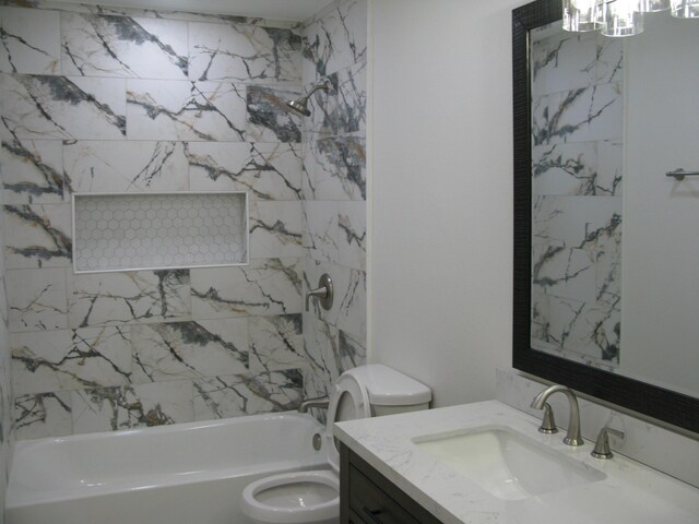 full bathroom with tiled shower / bath combo, toilet, and vanity