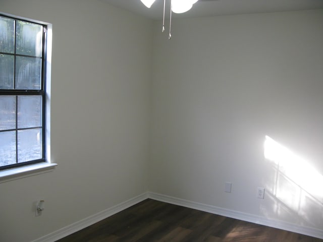 unfurnished room with dark hardwood / wood-style floors and ceiling fan