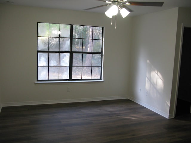 spare room with ceiling fan and dark hardwood / wood-style floors