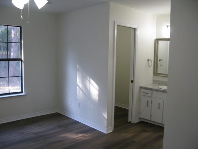 interior space with ceiling fan and dark wood-type flooring