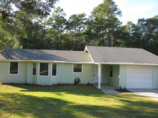 ranch-style home featuring a garage and a front yard