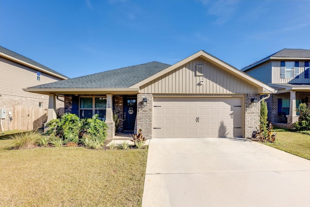 view of front of property with a front yard and a garage