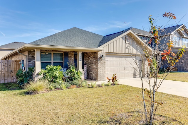 view of front of home featuring a front yard and a garage