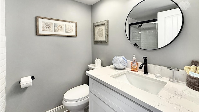 bathroom with vanity, toilet, and a shower with shower door