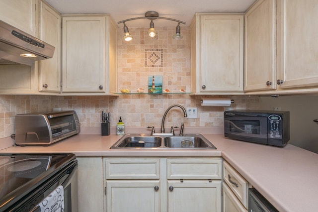 kitchen with tasteful backsplash, sink, black appliances, and ventilation hood