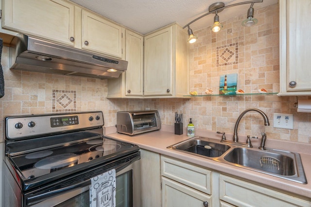 kitchen featuring cream cabinets, sink, backsplash, and stainless steel electric range