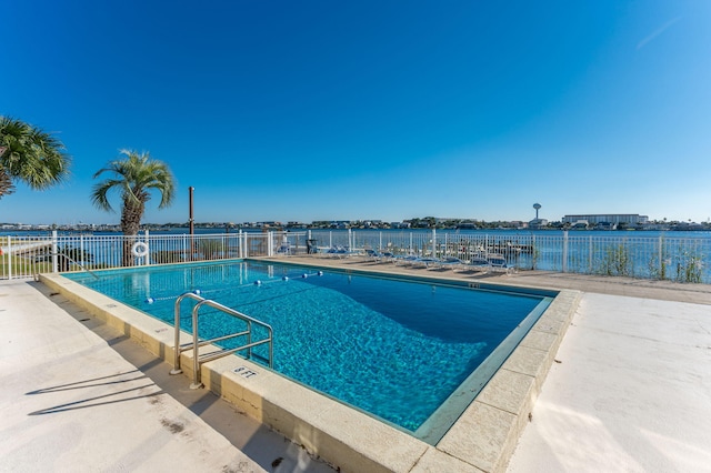 view of swimming pool featuring a patio area and a water view