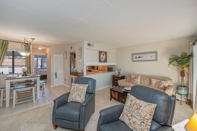 carpeted living room featuring a textured ceiling