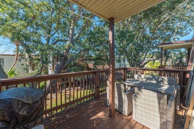 wooden terrace with a grill