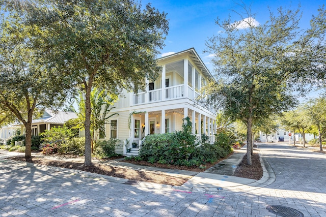 view of front of property with covered porch and a balcony