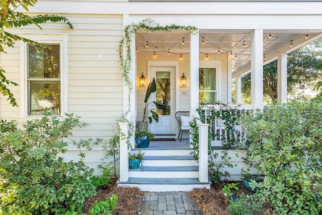 view of exterior entry featuring a porch