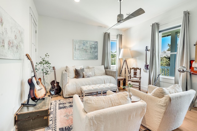 living room featuring ceiling fan, a healthy amount of sunlight, and light hardwood / wood-style floors