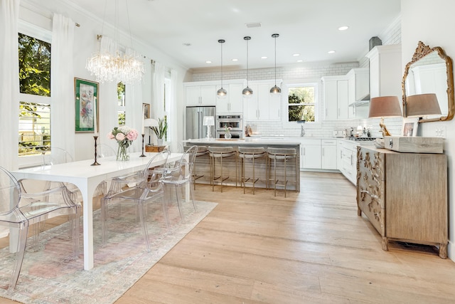 kitchen featuring a center island, stainless steel appliances, plenty of natural light, and hanging light fixtures