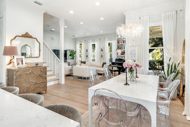 dining space with light wood-type flooring and crown molding