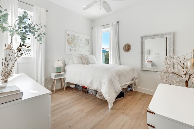 bedroom with ceiling fan and light hardwood / wood-style floors