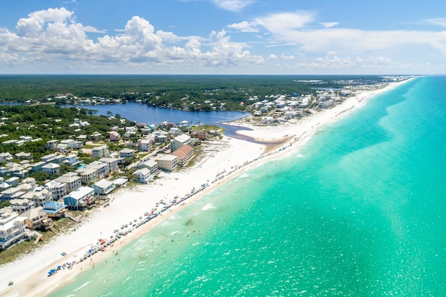 drone / aerial view featuring a water view and a beach view