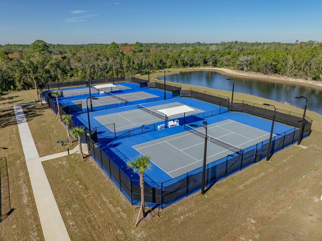 view of tennis court with a water view