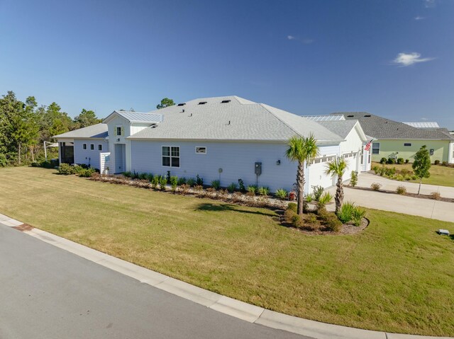 view of side of home with a yard and a garage