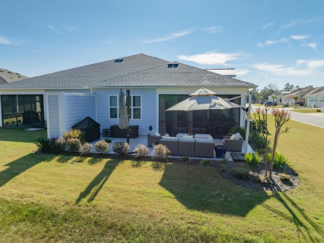 rear view of house with a lawn, an outdoor hangout area, and a patio