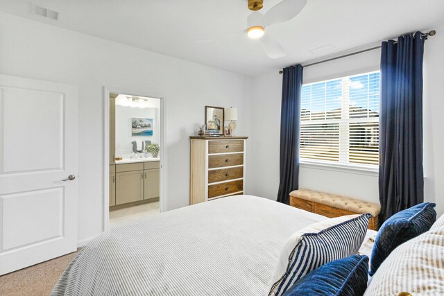 carpeted bedroom with connected bathroom and ceiling fan