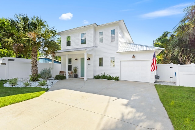 modern farmhouse with a garage, concrete driveway, and fence