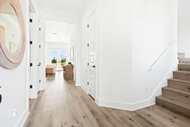 corridor featuring stairway, french doors, light wood-type flooring, and baseboards