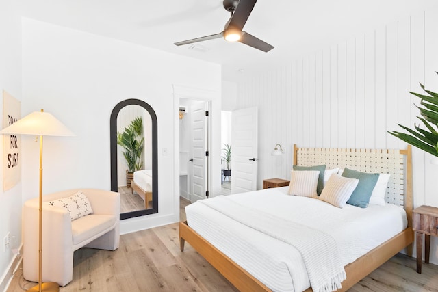 bedroom featuring arched walkways, visible vents, ceiling fan, and light wood-style floors