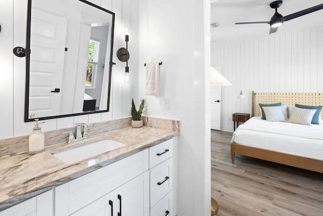 bathroom featuring visible vents, a ceiling fan, wood finished floors, and vanity