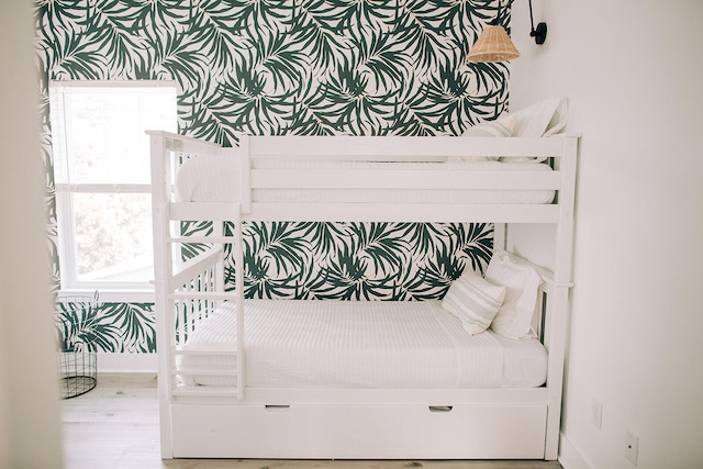 bedroom featuring baseboards and wood finished floors