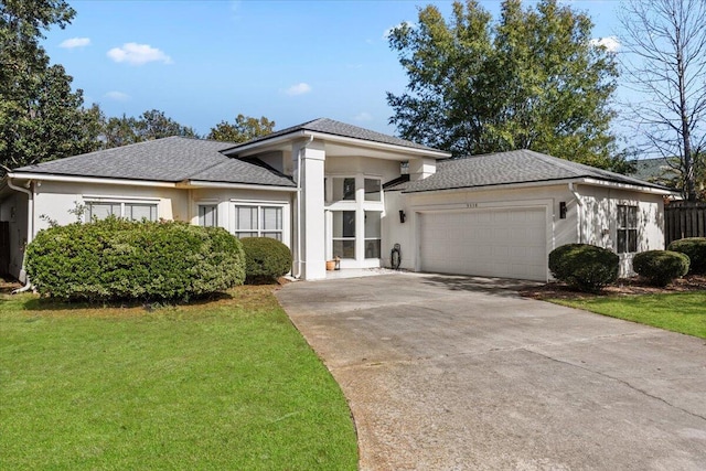 view of front of home with a garage and a front yard