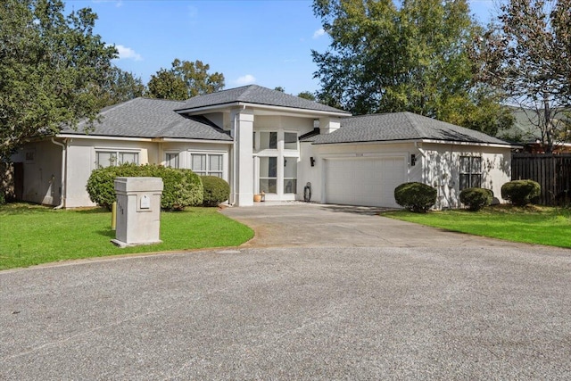 prairie-style house with a front yard and a garage