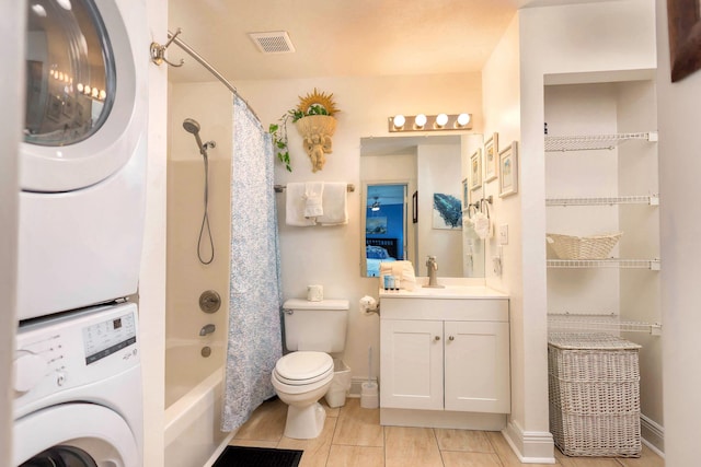 full bathroom with vanity, stacked washing maching and dryer, toilet, and shower / bath combo with shower curtain