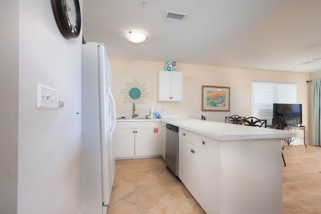 kitchen with dishwasher, sink, kitchen peninsula, white fridge with ice dispenser, and white cabinetry