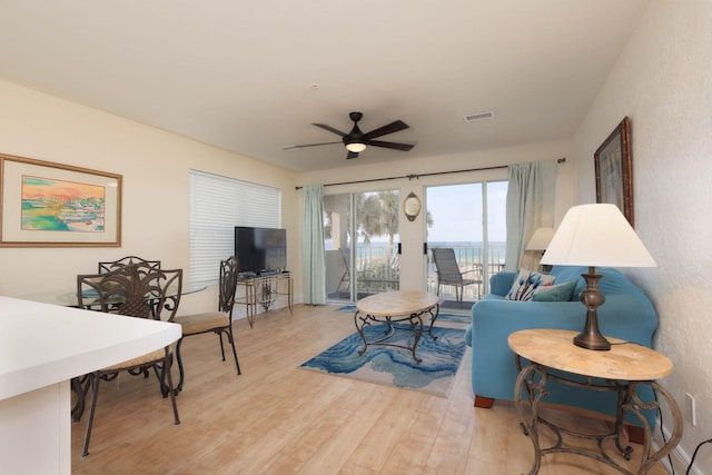 living room with light wood-type flooring and ceiling fan