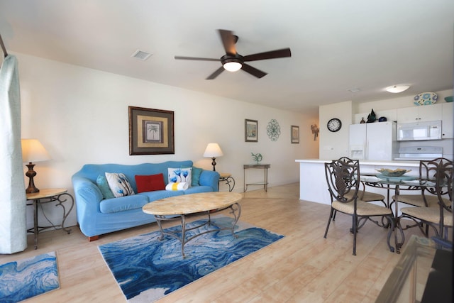 living room featuring ceiling fan and light wood-type flooring