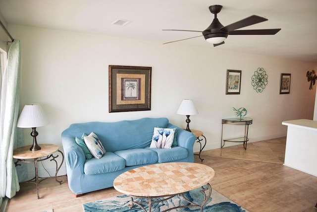 living room with ceiling fan and light hardwood / wood-style flooring