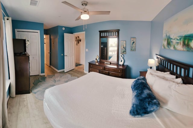 bedroom featuring ceiling fan, a closet, and light hardwood / wood-style flooring